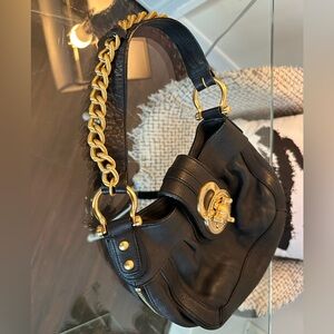 Soft black leather bag, chunky gold turnlock hardware.